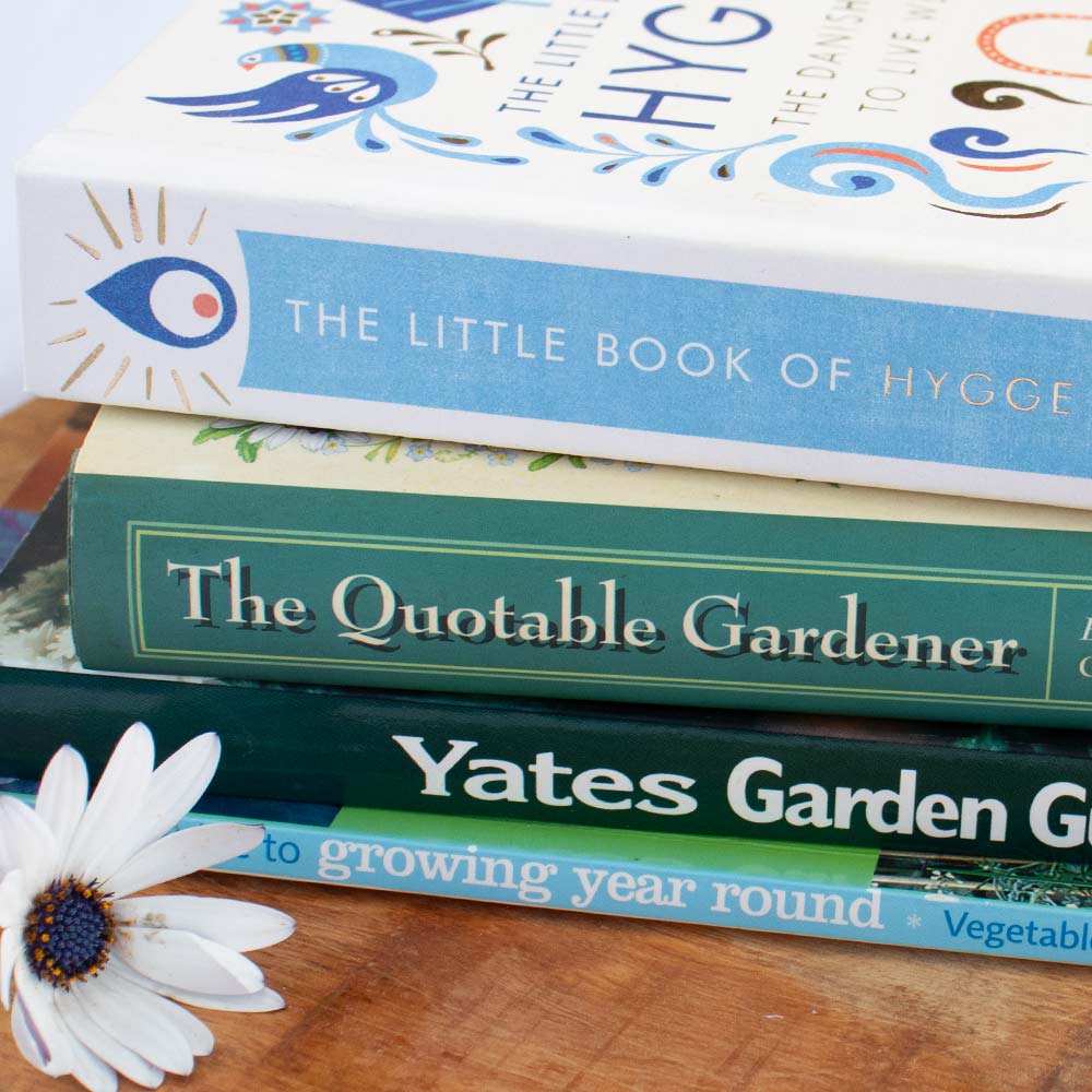 Image shows a stack of pre-loved second-hand giftable books sold on At The Helm NZ