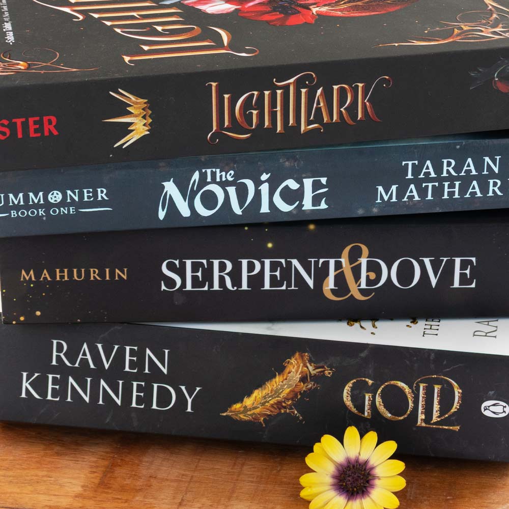 Image shows a stack of modern fiction second-hand books sold at At The Helm NZ