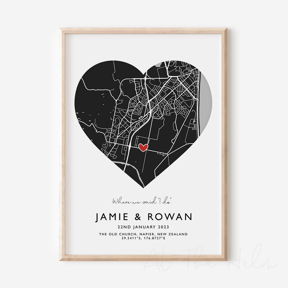 Framed black and white heart-shaped map print with text personalization.

A red heart marks a specific location. .Small cursive headline text reads " Where we said "i do". Secondary capitalized text (slightly larger) below that reads " Jaime & Rowan"  and then a personalised special date, location and map coordinates. 