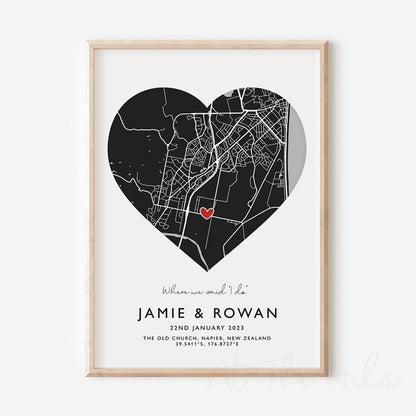 Framed black and white heart-shaped map print with text personalization.

A red heart marks a specific location. .Small cursive headline text reads " Where we said "i do". Secondary capitalized text (slightly larger) below that reads " Jaime & Rowan"  and then a personalised special date, location and map coordinates. 