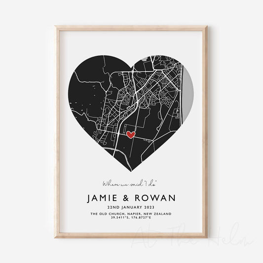 Framed black and white heart-shaped map print with text personalization.

A red heart marks a specific location. .Small cursive headline text reads " Where we said "i do". Secondary capitalized text (slightly larger) below that reads " Jaime & Rowan"  and then a personalised special date, location and map coordinates. 