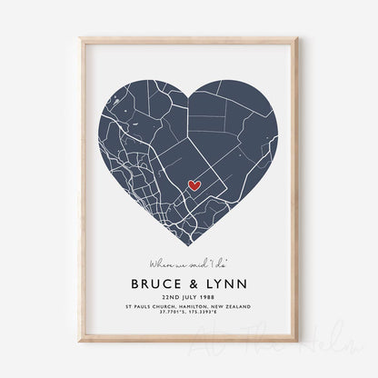 Framed blue and white heart-shaped map print with text personalization.

A red heart marks a specific location. 
Small cursive headline text reads " Where we said "i do"". Secondary capitalized text (slightly larger) below that reads " Bruce & Lynn"  and then a personalised special date, location and map coordinates. 