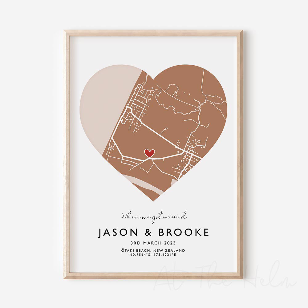 Framed brown and white heart-shaped map print with text personalization.

A red heart marks a specific location. 
Small cursive headline text reads " Where we got married". Secondary capitalized text (slightly larger) below that reads "JASON & BROOKE"  and then a personalised special date, location and map coordinates. 