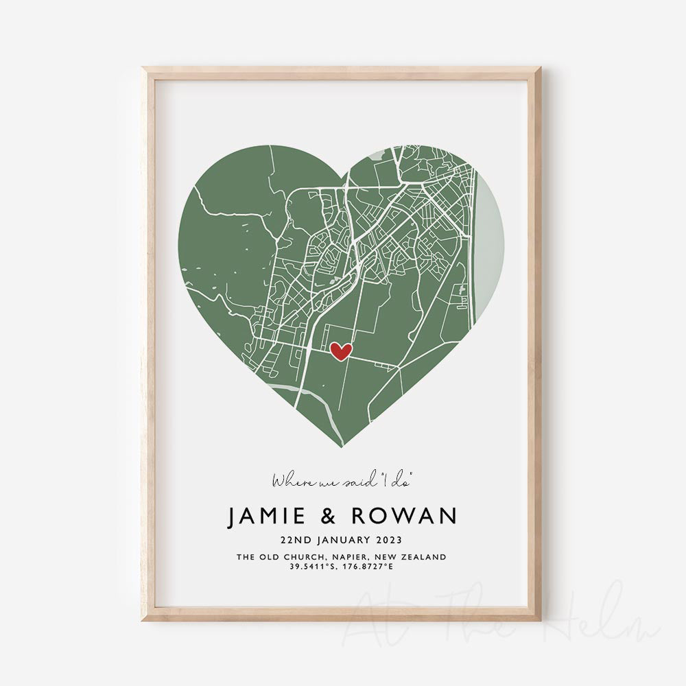 Framed green and white heart-shaped map print with text personalization.

A red heart marks a specific location. 
Small cursive headline text reads " Where we said "i do"". Secondary capitalized text (slightly larger) below that reads "JAMIE & ROWAN"  and then a personalised special date, location and map coordinates. 