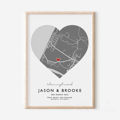 Framed grey and white heart-shaped map print with text personalization.

A red heart marks a specific location. Small cursive headline text reads " Where we got married". Secondary capitalized text (slightly larger) below that reads " Jason & Brooke"  and then a personalised special date, location and map coordinates. 