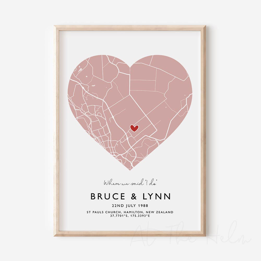 Framed pink and white heart-shaped map print with text personalization.

A red heart marks a specific location. 
Small cursive headline text reads " Where we said "i do"". Secondary capitalized text (slightly larger) below that reads " Bruce & Lynn"  and then a personalised special date, location and map coordinates. 