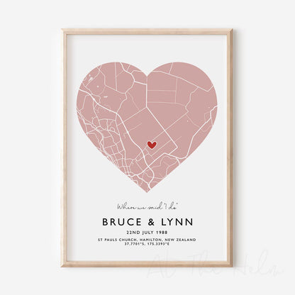 Framed pink and white heart-shaped map print with text personalization.

A red heart marks a specific location. 
Small cursive headline text reads " Where we said "i do"". Secondary capitalized text (slightly larger) below that reads " Bruce & Lynn"  and then a personalised special date, location and map coordinates. 