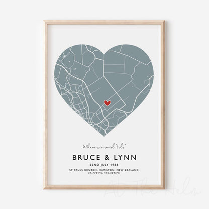 Framed light blue and white heart-shaped map print with text personalization.

A red heart marks a specific location. 
Small cursive headline text reads " Where we said "i do"". Secondary capitalized text (slightly larger) below that reads " Bruce & Lynn"  and then a personalised special date, location and map coordinates. 
